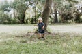 Precious Little Toddler Boy Dressed Up in the Outdoors Forest Park for Portraits in Autumn by Big Natural Tree Having Excited Fun Royalty Free Stock Photo