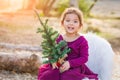 Precious Mixed Race Young Baby Girl Holding Small Christmas Tree Royalty Free Stock Photo