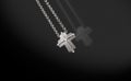 Precious platinum chain with cross diamonds on black background.