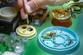 Precious pocket watch disassembled on the clockmaker work table