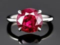 Precious ruby gemstone ring classic piece of jewelry sparking with red passion. elegant gem reflect on dark surface Royalty Free Stock Photo