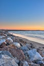 Precious sand protected by wall of rocks from pounding surf.