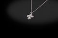 Precious silver chain with cross diamonds on a black background.