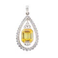 Precious silver pendant with a yellow gemstone under the lights isolated on a white background