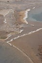 Precipitated salt forms a snowy outline of thermal pools