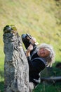 Precise devoted senior artist carving in stone