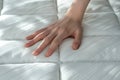 Precise selection: the hand tests the bed mattress, ensuring a perfect sleep and comfortable rest