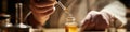 Precisely dispensing a golden liquid: Scientist's hand with a dropper in a mysterious lab. Royalty Free Stock Photo