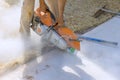 Precision Concrete Paving Sidewalk Cutting by Skilled Construction Worker with Diamond Blade Saw Royalty Free Stock Photo