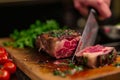 Precision in cooking Chefs hands cutting a large beef portion