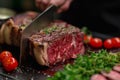 Precision in cooking Chefs hands cutting a large beef portion