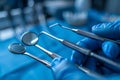 Precision dental instruments in blue gloves: focus on dental health and hygiene. Macro shot of a dentist's hands in Royalty Free Stock Photo