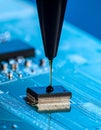 Precision Epoxy Application on a Microchip Royalty Free Stock Photo