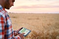 Precision farming. Farmer hands hold tablet using online data management software, differential fertilizer application Royalty Free Stock Photo