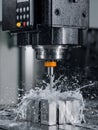 Precision Machining Process With Water Cooling on Metal Block in an Industrial Workshop Setting Royalty Free Stock Photo