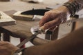 Precision in Progress: Woodworker Shaping and Smoothing with a File Royalty Free Stock Photo