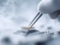 Precision work gloved hand uses tweezers on a CPU, symbolizing technology, engineering, and innovation. Perfect for illustrating Royalty Free Stock Photo