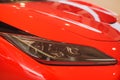 Predatory car headlight and hood of powerful sports car with matte paint.