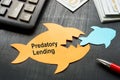 Predatory lending concept. Two paper fish on the office table. Royalty Free Stock Photo
