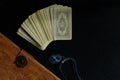 Fortune-telling on cards. Vintage deck of cards, a book of spells in a leather cover and an amulet with a precious stone