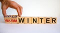Predition for a cold winter. Hand turns cubes and changes the words `warm winter` to `cold winter`. Beautiful white background Royalty Free Stock Photo