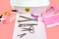 Predsterilizatsionnoy cleaning. disinfection of the used manicure tool in a chemical solution on a pink background. top view. the