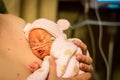 Preemie baby girl enjoying skin to skin with dad