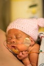 Preemie baby girl enjoying skin to skin with dad