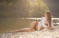 Preety woman in swimsuit near alpine river in early summer Royalty Free Stock Photo