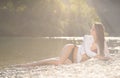 Preety woman in swimsuit near alpine river in early summer Royalty Free Stock Photo