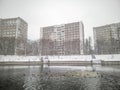 Prefabricated reinforced concrete apartment buildings in winter on the shore of the lake. Royalty Free Stock Photo