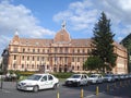 Prefecture building and line of standing cabs on the street in center of Brasov