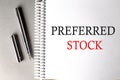 PREFERRED STOCK text on a notebook with pen on grey background
