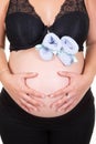 Pregnancy belly tummy of pregnant woman with baby first shoes on white background Royalty Free Stock Photo