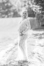 Pregnancy. Black and White - monochrome. Beautiful pregnant woman in sheer long lacy white maternity dress Royalty Free Stock Photo