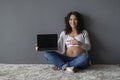 Pregnancy Blog. Smiling Expectant Female Pointing At Laptop With Blank Black Screen