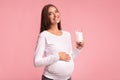 Pregnant Woman Holding Glass Of Milk Standing Over Pink Background Royalty Free Stock Photo