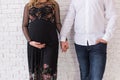 Pregnancy concept. Happy pregnant couple holds hands of each other. Pregnant family holding hands. Concept of union, support and f Royalty Free Stock Photo