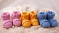 Pregnancy concept, Three pairs of baby booties on a light background.