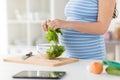 Close up of pregnant woman cooking food at home Royalty Free Stock Photo