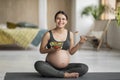 Pregnancy Diet. Happy Pregnant Young Woman Eating Fresh Vegetable Salad At Home Royalty Free Stock Photo