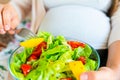 Pregnancy eating healthy salad. Happy pregnant woman eating nutrition food. People lifestyle food concept. Royalty Free Stock Photo