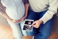 Close up of couple with baby ultrasound images Royalty Free Stock Photo