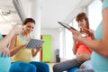 Happy pregnant women with tablet pc in gym