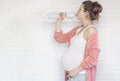 Pregnancy health lifestyle young pregnant woman drinking water from a bottle Royalty Free Stock Photo