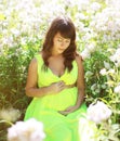 Pregnancy lovely woman in flowers