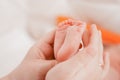 Pregnancy, maternity, preparation and expectation motherhood, giving birth concept. Newborn baby feet in hands of mommy Royalty Free Stock Photo