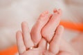 Pregnancy, maternity, preparation and expectation motherhood, giving birth concept. Newborn baby feet in hands of mommy Royalty Free Stock Photo