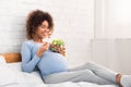 Pregnancy meal plan. African-american woman eating fresh vegetable salad Royalty Free Stock Photo