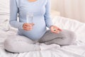 Unrecognizable Pregnant Girl Holding Pills And Water Sitting On Bed Royalty Free Stock Photo